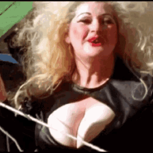 a close up of a woman 's breasts in a black dress .