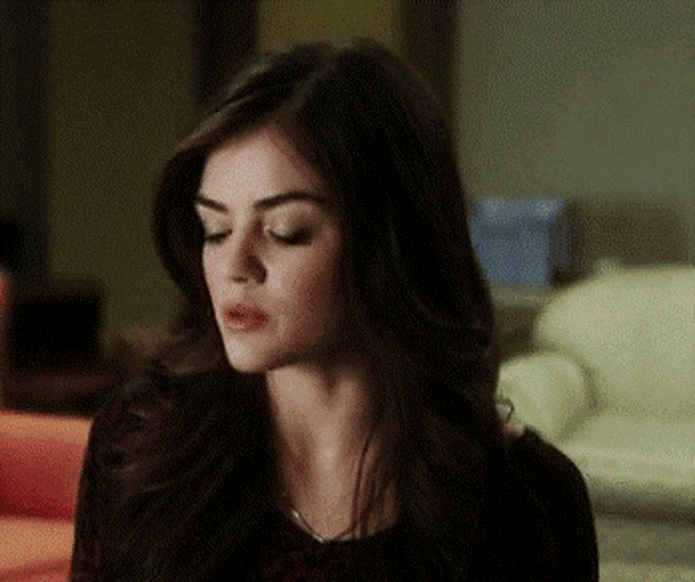 a close up of a woman 's face with dark hair