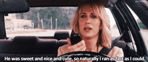 a woman is driving a car and talking on her phone