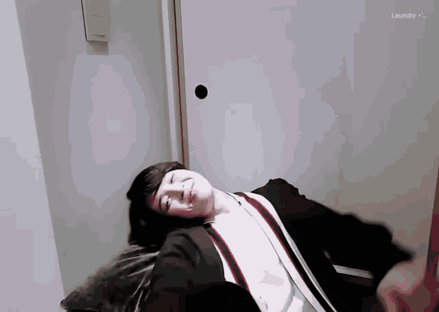 a person laying on a couch with the word laundry behind them