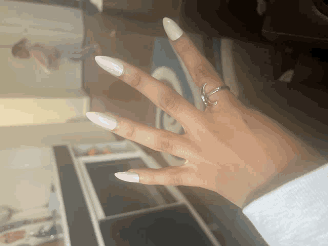 a close up of a woman 's hand with a ring on it