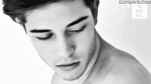 a close up of a man 's face with his eyes closed .