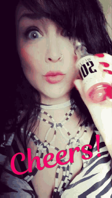a woman in a zebra print shirt is holding a bottle that says cheers