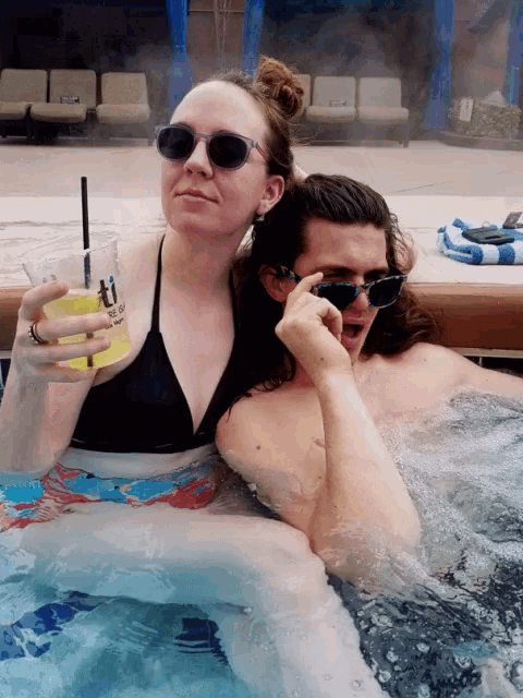 a man and a woman are sitting in a hot tub