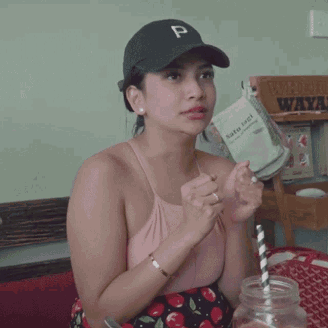 a woman wearing a hat with a letter p on it