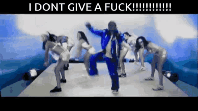 a group of people are dancing on a stage with the words i dont give a fuck on the bottom