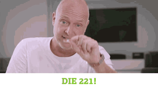 a man in a white shirt with the words die 221 on the bottom right