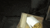 a bag of food is sitting on top of a wooden table .