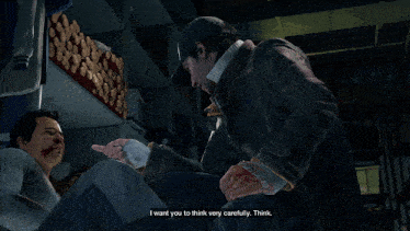 a man in a video game is talking to another man who is laying on the floor