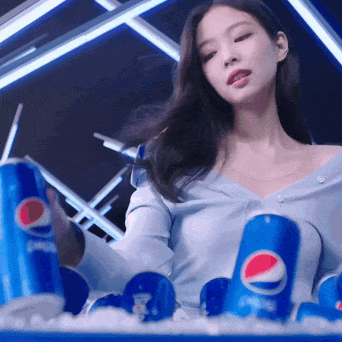 a woman is holding a can of pepsi