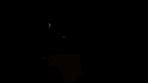 a dark room with a few lights on the ceiling .