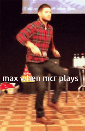 a man in a plaid shirt is dancing with the words max when mcr plays on the bottom