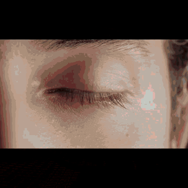 a close up of a person 's eye with their eyelid closed