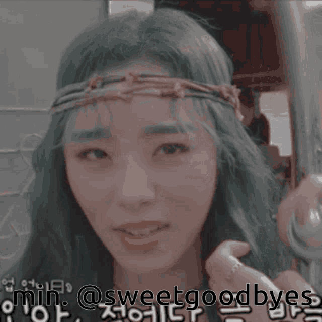 a woman with green hair is smiling with the words min @sweetgoodbyes behind her