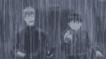a couple of people are standing in the rain .