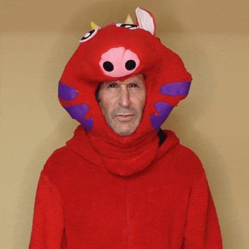 a man in a red costume with a pig head