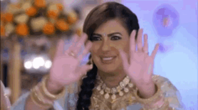 a woman is making a funny face with her hands in the air .