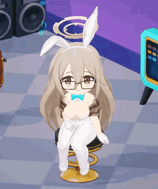 a girl in a bunny costume is sitting in a chair