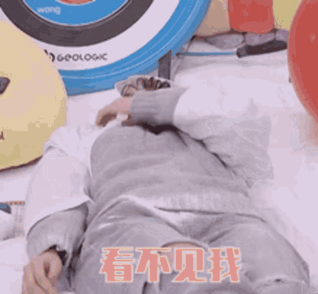a person is laying on the floor with chinese writing on the floor