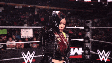 a woman in a wrestling ring with a sign that says run low on it