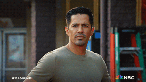 a man is standing in front of a building with a nbc logo on the bottom right