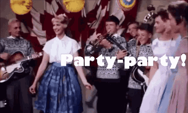 a group of people are dancing in front of a band with the words party-party written in white