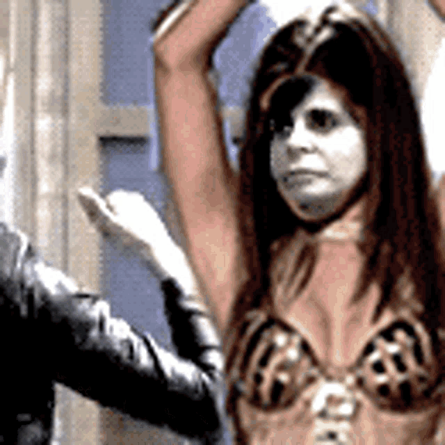 a woman in a costume with her arms in the air is being held by a man .