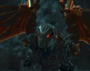 a close up of a red monster with wings in the dark