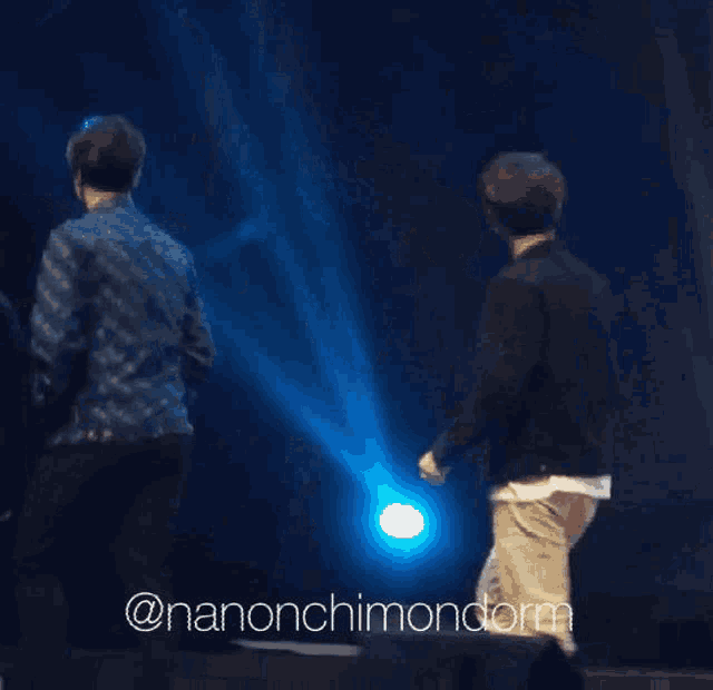 a blurry photo of a man and a woman dancing on a stage with a caption that says @nanonchimondom