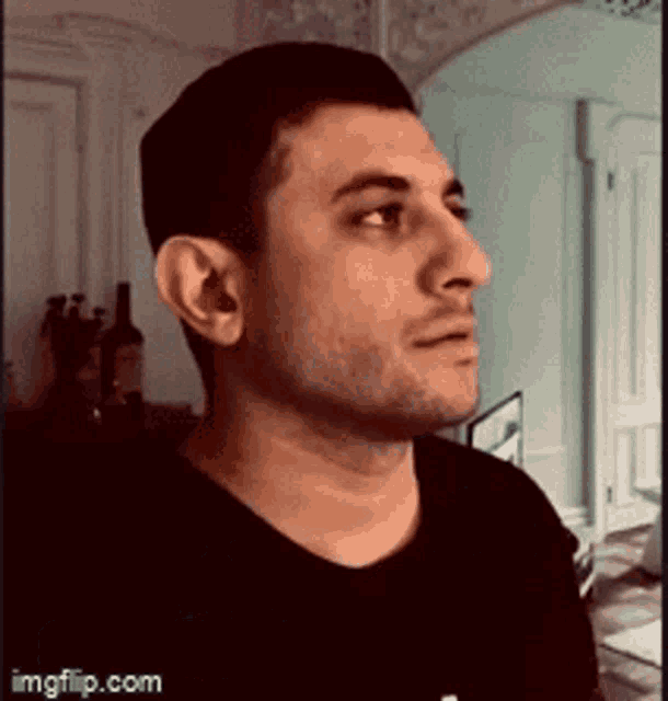 a man in a black shirt is looking at something