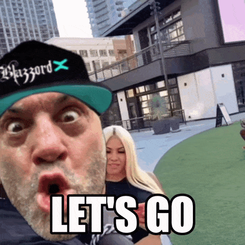 a man wearing a blizzard hat says let 's go in front of a woman