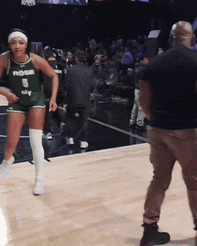 a female basketball player wearing a jersey that says rose on it