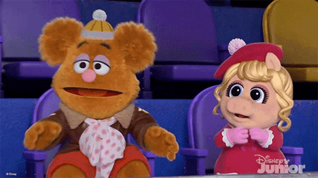 two stuffed animals sitting next to each other with disney junior written on the bottom