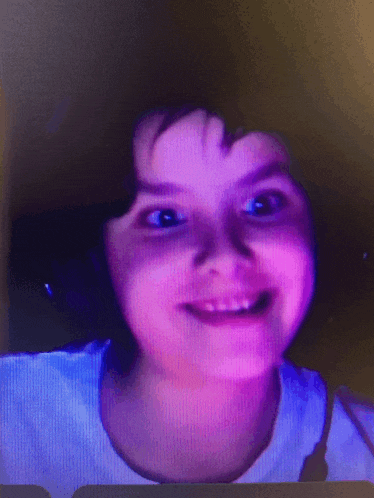 a girl with a purple background is smiling