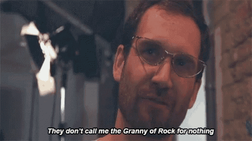 a man wearing glasses is smiling and says they don 't call me the granny of rock for nothing