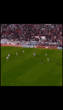 a blurry picture of a soccer player in front of a coca cola ad