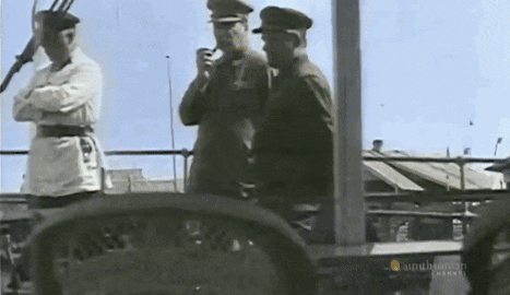 a black and white photo of a man smoking a pipe and another man smoking a pipe