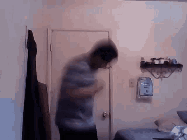 a blurry picture of a man in a bedroom