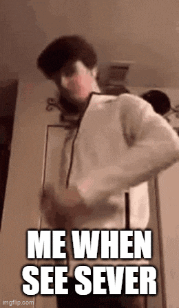 a man in a white hoodie is standing in front of a door with the words `` me when see sever '' written on it .
