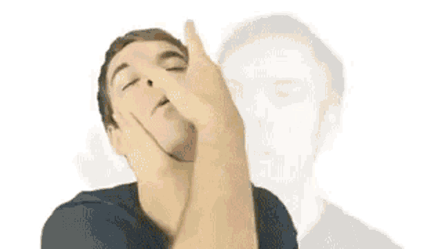 a man is making a face with his hand on his face .