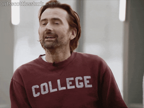 a man wearing a maroon sweatshirt that says college on it