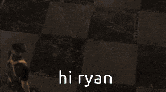 a blurred image of two people with the words hi ryan in white letters