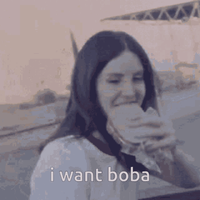 a woman eating a sandwich with the words " i want boba " written below her
