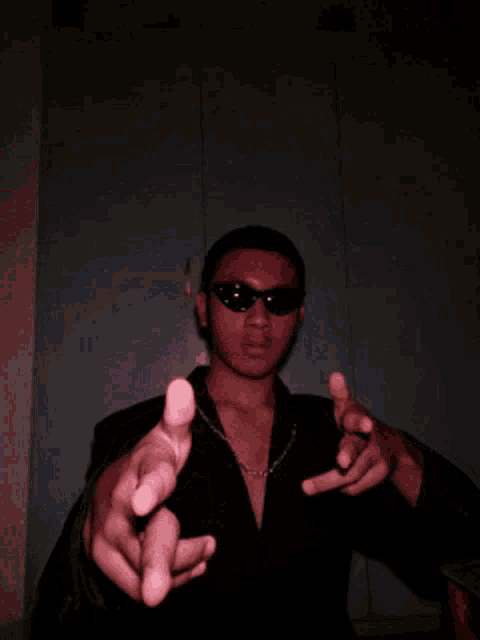 a man wearing sunglasses is making a funny face