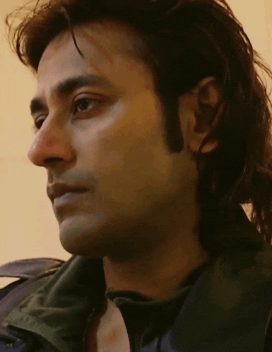 a close up of a man 's face with a serious look on his face