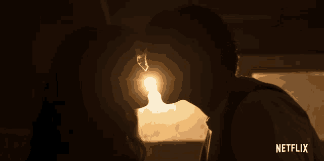 a silhouette of a man and woman kissing with a netflix logo behind them