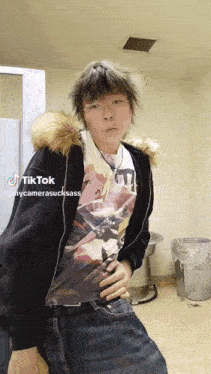a person wearing a fur hooded jacket and a t-shirt with a picture of a woman on it