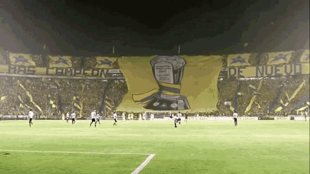 soccer players on a field with a banner that says mas campeon de nuevo
