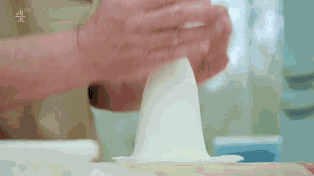 a close up of a person 's hands on a table with the letters 4hd above them