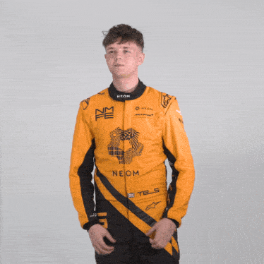a man wearing a yellow and black racing suit that says neom
